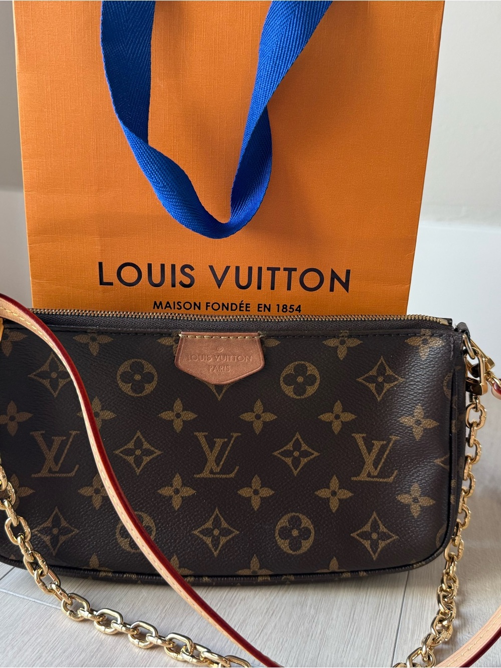 Louis Vuitton Monogram Pochette in Brown with Tan Trim and Gold Hardware.